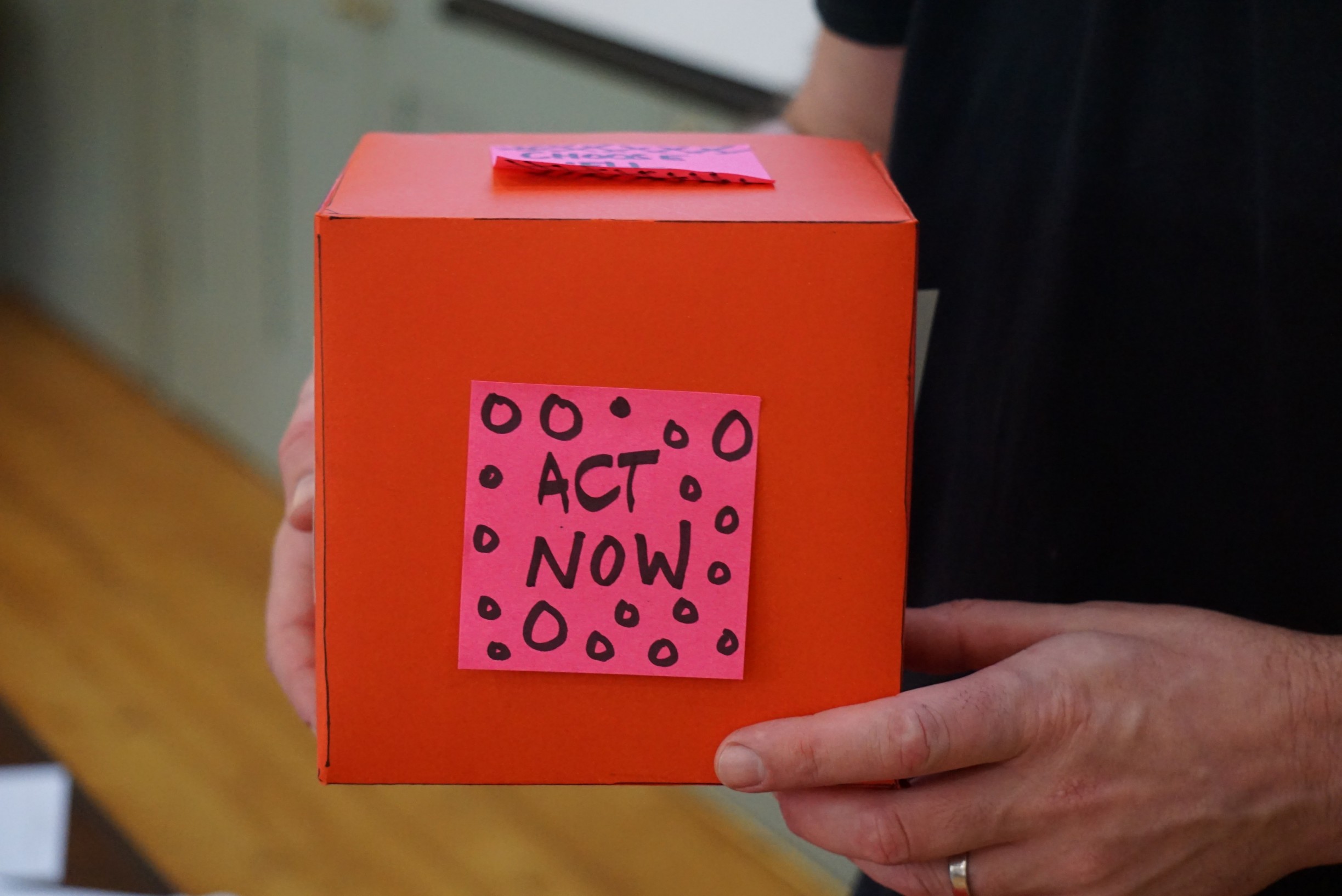 A red box with stickies on it, mocking up a conceptual product